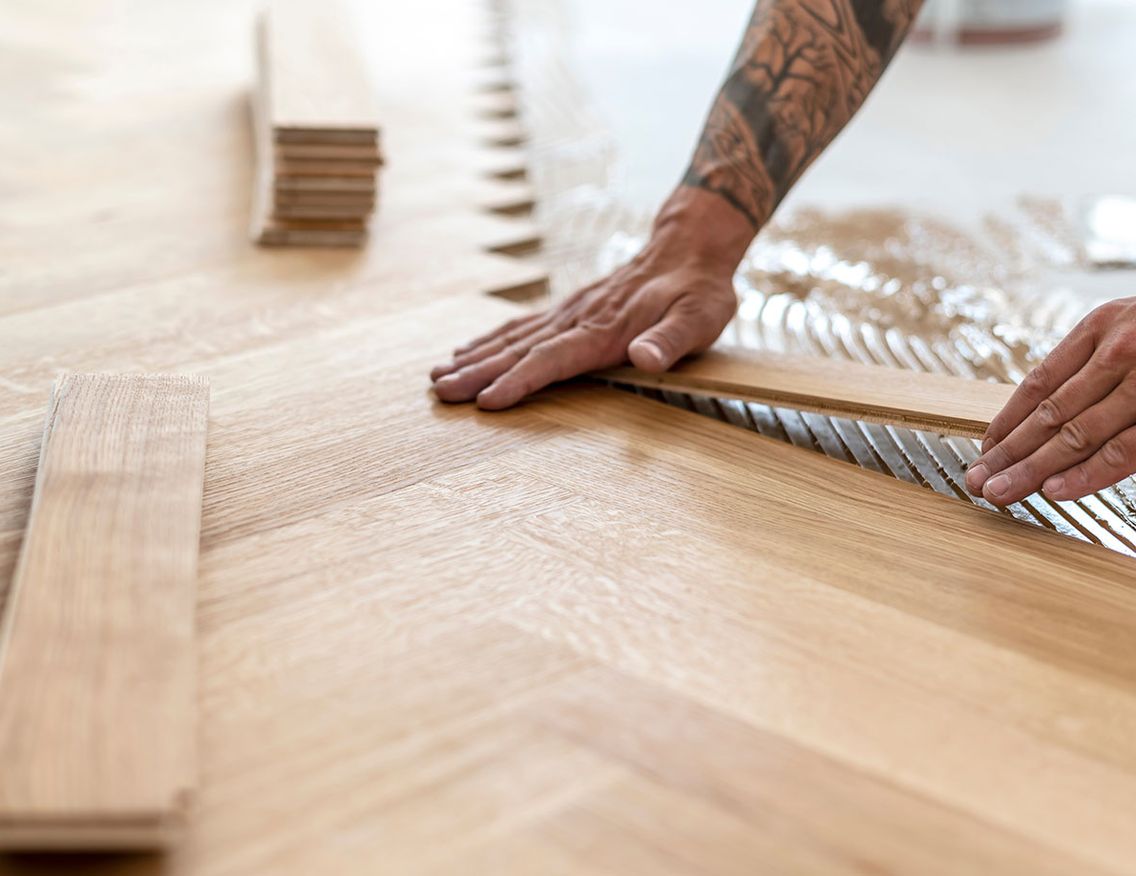 Carpenter installing parquetry floor